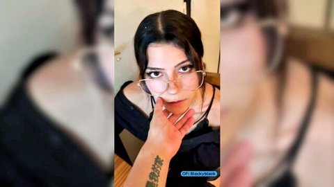 Blacky in glasses and off-shoulder top, seductive close-up with tattoo