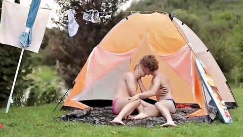 Two hot muscular studs kissing passionately naked in an outdoor tent