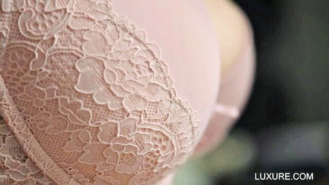 Busty woman's huge tits spilling from sexy pink lace bra cleavage