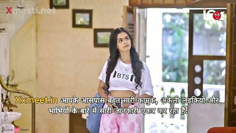 Cute Indian teen in BTS crop top and pink pants stands teasingly in taboo home scene