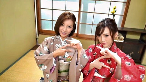 Two sexy Japanese babes in kimonos making cute finger hearts together