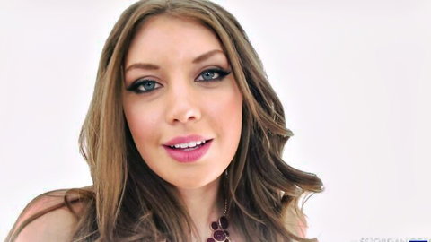 Seductive brunette with smoky green eyes and glossy pink lips smiling teasingly.