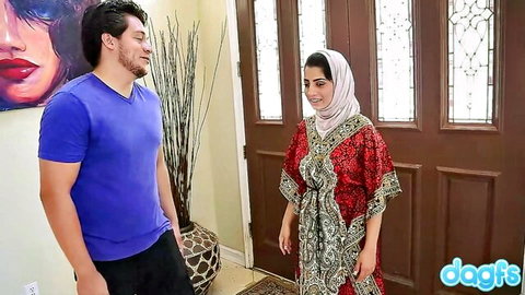 Nadia Ali in hijab dress with David Loso at door encounter