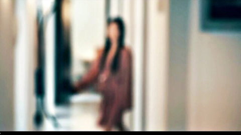 Blurry Japanese woman in brown dress smoking in dimly lit hallway, JAV style