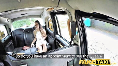 Young brunette in short white dress sits legs apart in Fake Taxi cab pickup