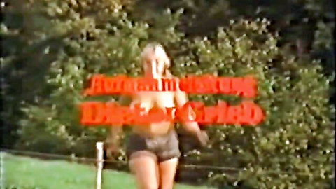 Vintage blonde teen exposing tits outdoors in tight shorts holding pole smiling