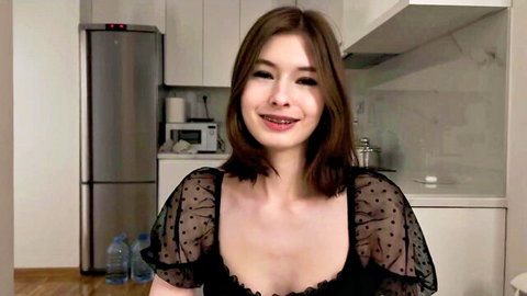 Kim smiles with braces in sheer black top showing cleavage, amateur tease
