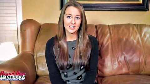 Brunette amateur smiling seductively on leather living room couch in tight leopard top POV