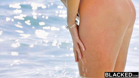 Fair-skinned skinny babe bends over showing wet bare ass and thighs at beach