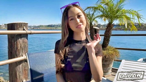 Petite young Asian in sheer black mesh top teasing small natural tits by beach