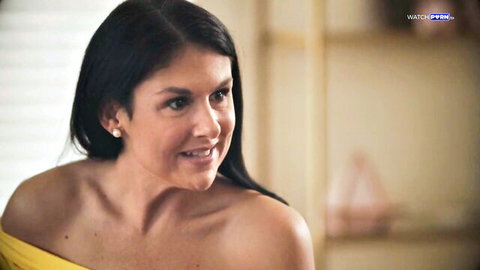 Smiling brunette MILF in sexy yellow off-shoulder top teasing with cleavage