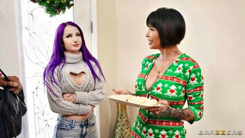 Purple-haired babe flashes huge tits in gray heart sweater as tattooed brunette in slutty green Christmas lingerie holds cookies