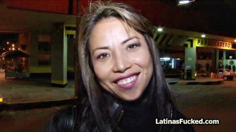 Smiling hot Latina in tight black leather jacket on night street pickup