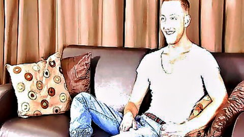 Jonny Kingdom in casual white shirt and jeans, smiling intimately