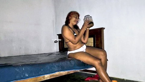 Malathi Akka in skimpy white bikini, teasing with jar on bed