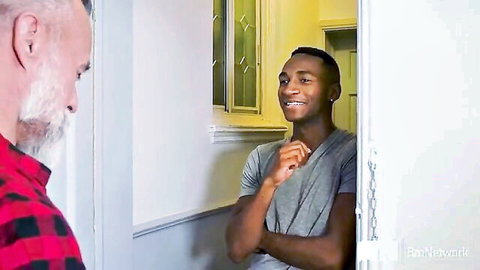 Older white daddy and young black twink flirt in doorway, anal lesson preview
