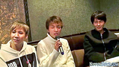 Three young Japanese guys in casual clothes, teasing Japanese orgy blowjob scene