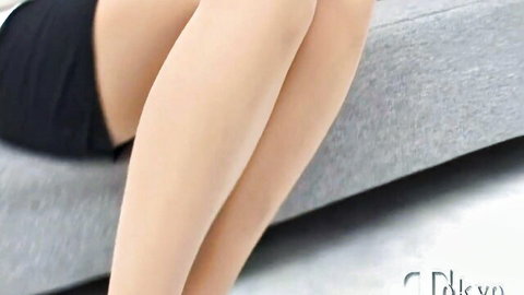 Skinny Japanese teen spreads pale legs wide in short black skirt teasing on couch