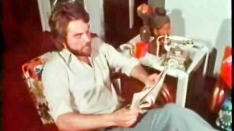 Vintage bearded white man with black woman in 70s interracial setup