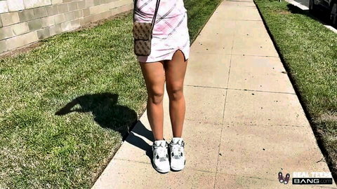 Ada Lyn teasing in pink mini skirt and white sneakers outdoors