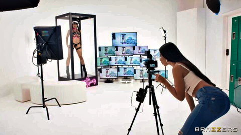 Camerawoman films sexy lingerie babe posing with ass out and boots in glass booth