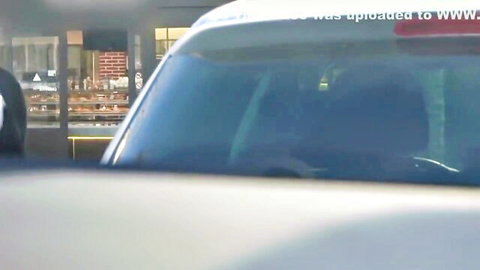 Blurry car windshield view in parking garage with silhouettes inside