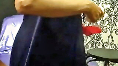 Playful MILF dangles red panties teasing on webcam in shiny dress