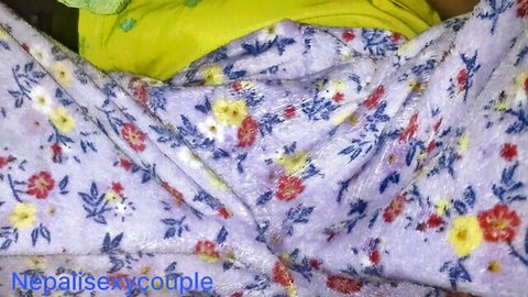 Rumpled floral purple blanket and yellow sheets with missexycouple watermark on bed