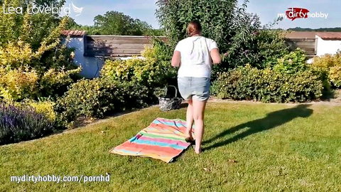 Blonde babe in tiny denim shorts walks barefoot on grass outdoors teasing her big juicy ass