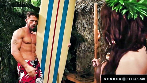 Muscular surfer hunk embraces topless brunette babe in tropical paradise