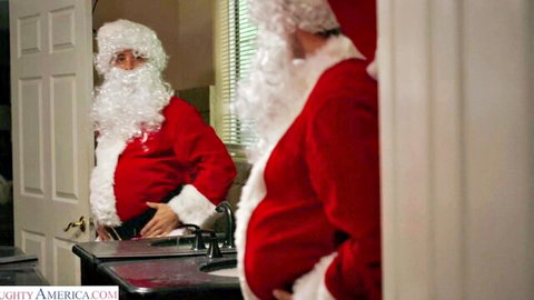 Busty blonde Syren De Mer as naughty Santa in bathroom mirror