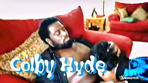 Ebony babe deepthroating muscular black stud's monster cock on red couch