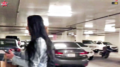Curvy brunette in shiny tight dress walks seductively showing big ass in parking garage