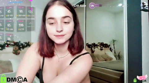 Cute redhead webcam girl squeezes her big tits in black bra smiling
