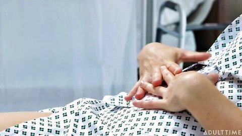 Hands spreading open green hospital gown on patient in medical roleplay fetish