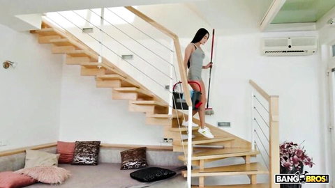 Petite skinny Asian girl cleaning stairs in short grey dress