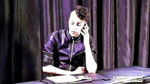 Tattooed kinky stranger in leather jacket on phone, previewing lesbian pound session