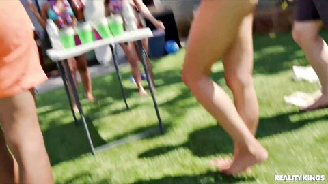Asian cutie in bikini at outdoor party with friends, legs and feet focus