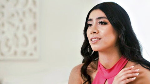 Violet Myers in seductive pink halter top, smiling sideways