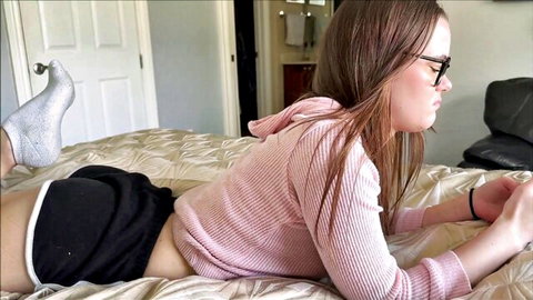Trinity Olsen small tits babe in pink hoodie and shorts lying on bed