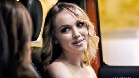 Seductive blonde in yellow top with another woman in car