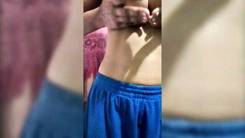 Married Asian woman in blue shorts with hands caressing her midriff