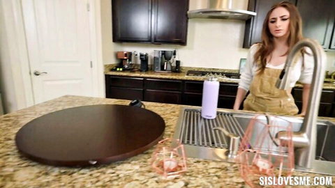 Penelope Kay in denim overalls posing playfully in kitchen prank scene