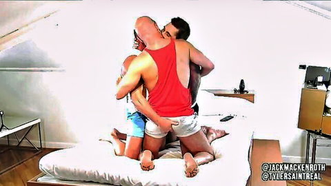 Ace Banner and Tyler Saint in steamy gay threesome embrace on bed