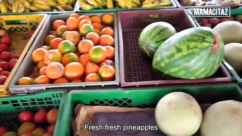 MamacitaZ market display of fresh pineapples, oranges, bananas and watermelons