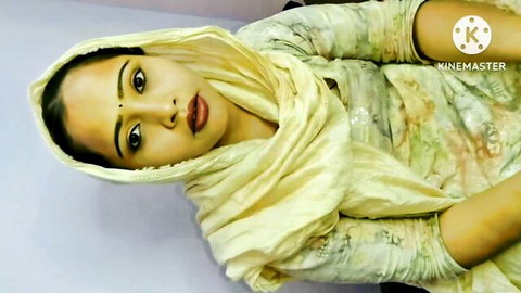 Seductive South Asian beauty in yellow hijab with big eyes and plump lips teasing close-up