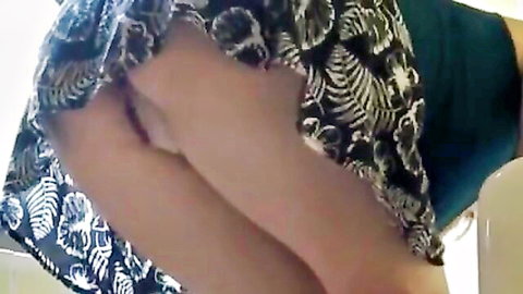 Japanese woman in patterned skirt bent over exposing intimate areas