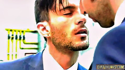 Two muscular bearded hunks in suits passionately kissing close-up