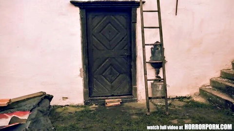 Creepy wooden door with ladder and bucket in spooky abandoned house for horror porn tease