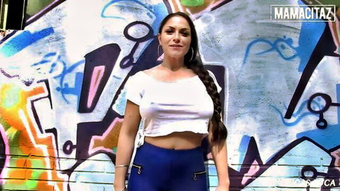 Marta La Croft posing sexy in tight white crop top and blue pants outdoors